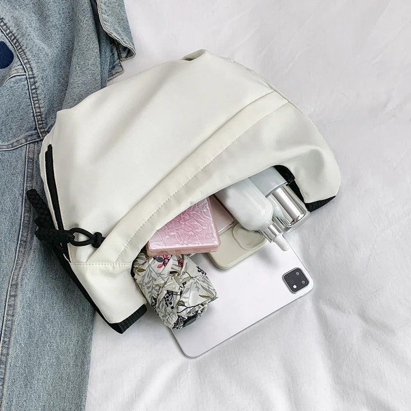Neutral style tote bag with strap for carrying fitness items. New mini street-style handbag with shoulder strap. Lightweight and